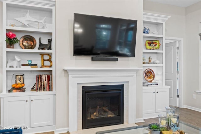 living room featuring light hardwood / wood-style floors and built in features