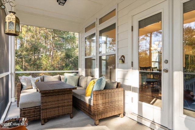 sunroom / solarium featuring french doors