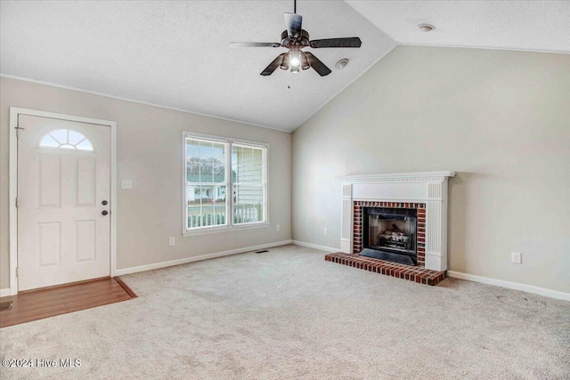 unfurnished living room with light carpet, a fireplace, ceiling fan, and lofted ceiling