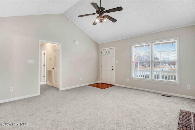 interior space with light colored carpet, vaulted ceiling, and ceiling fan