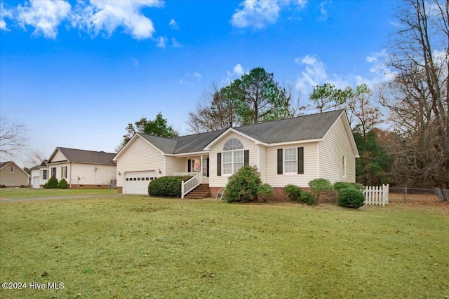 view of front facade with a front yard and a garage