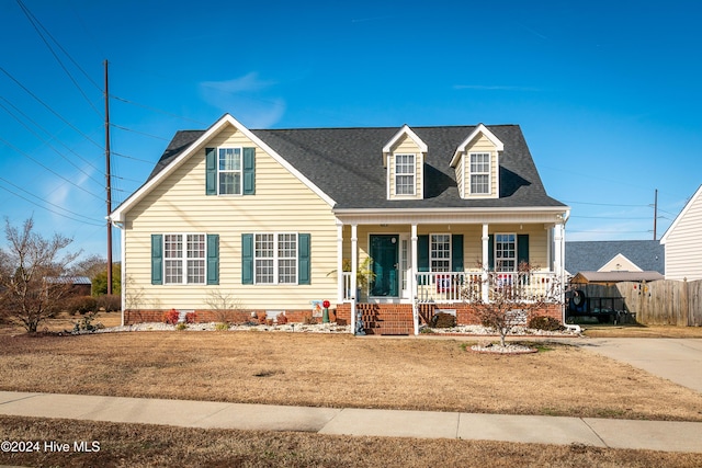 new england style home featuring covered porch