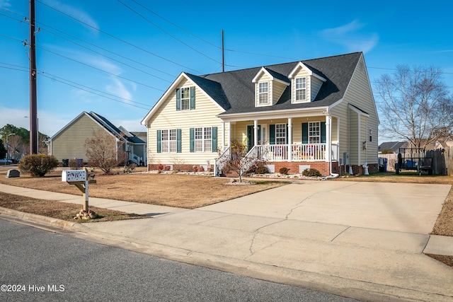 new england style home with a porch