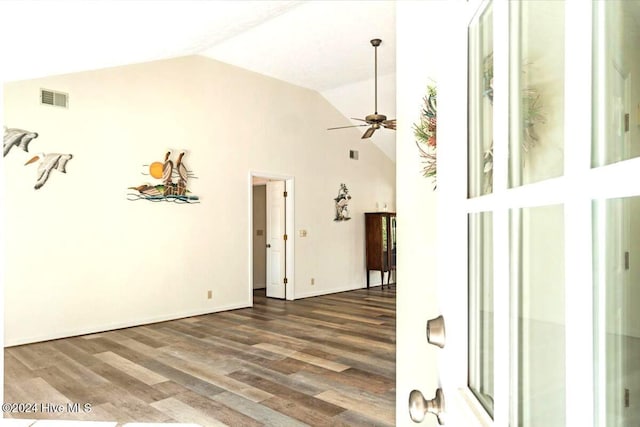 empty room with dark hardwood / wood-style flooring, ceiling fan, and lofted ceiling