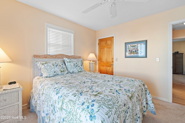 bedroom featuring light carpet and ceiling fan