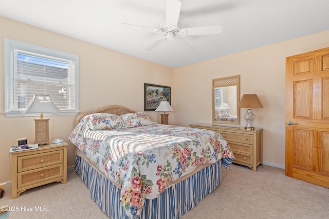 bedroom with ceiling fan and light carpet