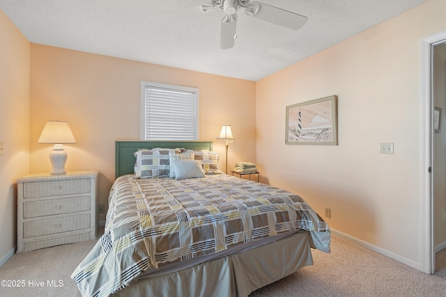 carpeted bedroom featuring ceiling fan and a textured ceiling