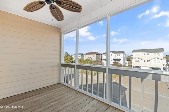 sunroom / solarium featuring ceiling fan