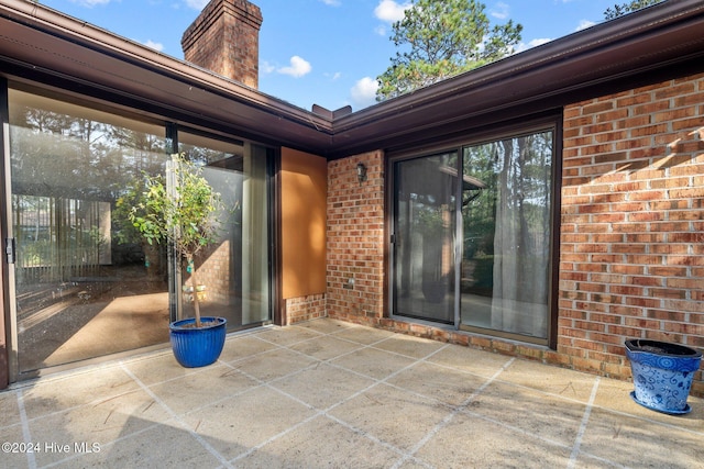 entrance to property featuring a patio