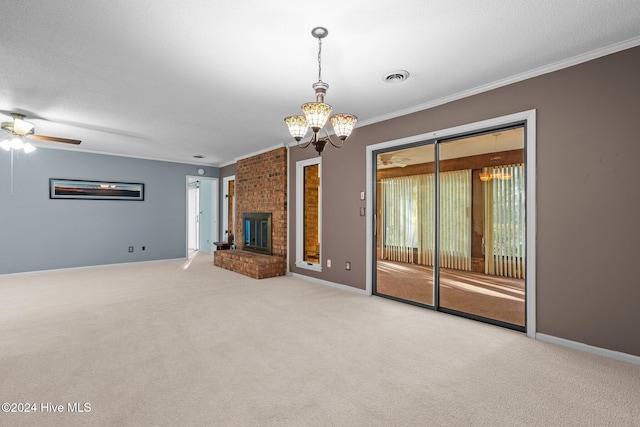 unfurnished living room with ornamental molding, a textured ceiling, ceiling fan with notable chandelier, light colored carpet, and a fireplace