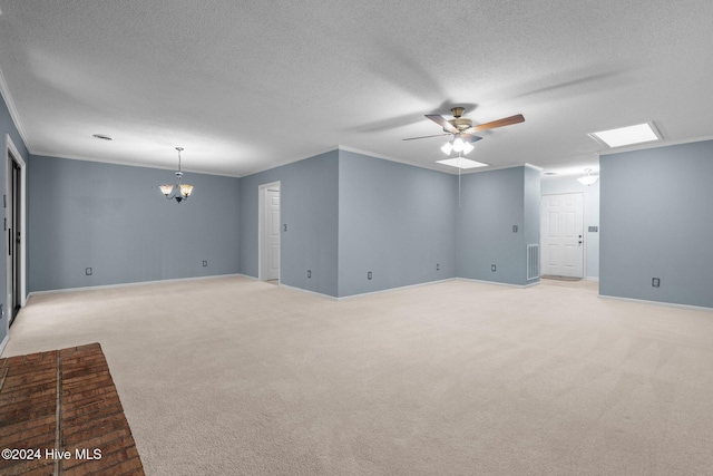 carpeted spare room featuring ceiling fan with notable chandelier, a textured ceiling, and ornamental molding