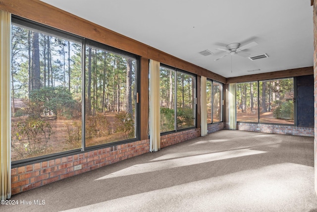 unfurnished sunroom with ceiling fan