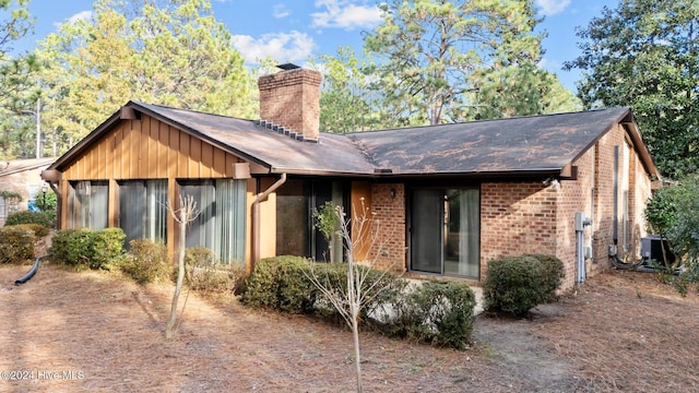 back of property with a sunroom