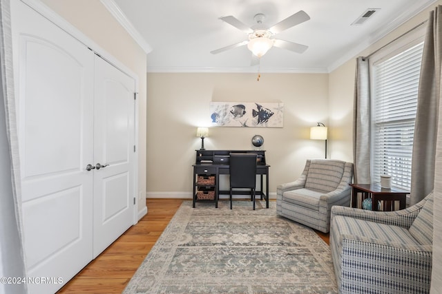 sitting room featuring crown molding, hardwood / wood-style floors, and ceiling fan