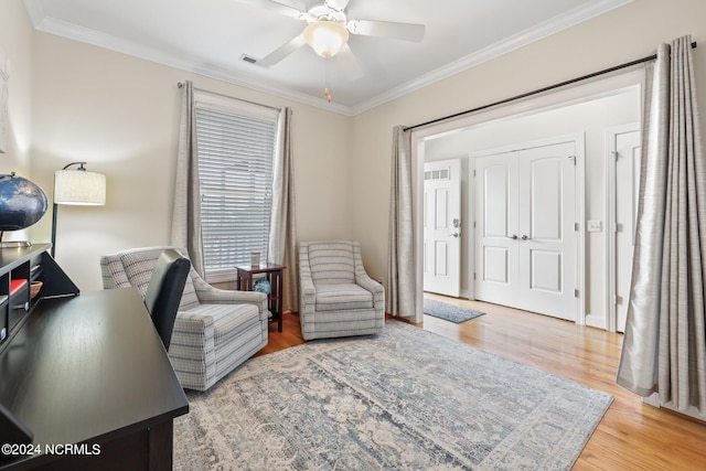 interior space with crown molding, hardwood / wood-style floors, and ceiling fan