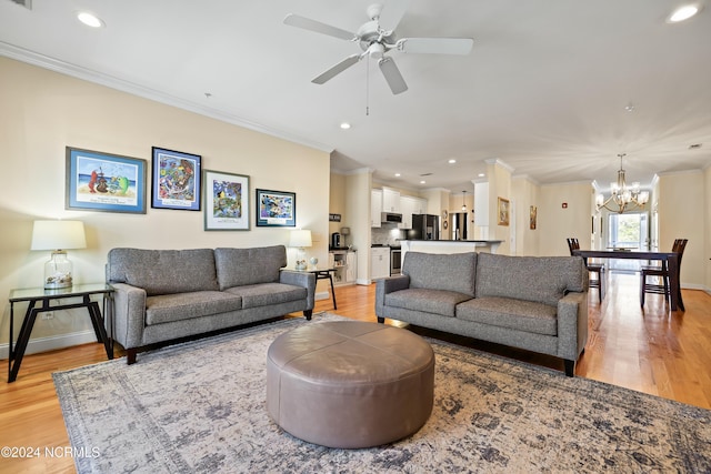 living room with crown molding and light hardwood / wood-style flooring