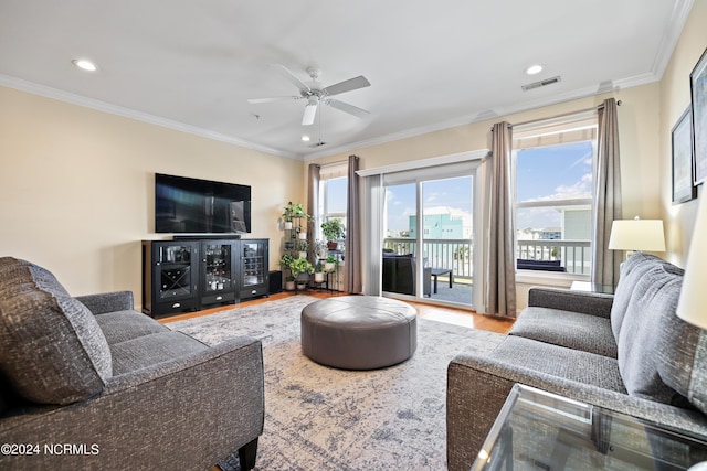 living room featuring hardwood / wood-style flooring, crown molding, and ceiling fan