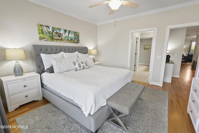 bedroom featuring crown molding, ceiling fan, and light hardwood / wood-style floors