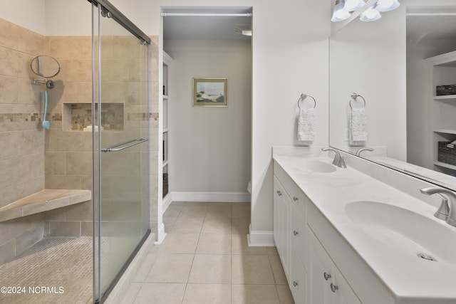 bathroom featuring vanity, a shower with shower door, and tile patterned flooring