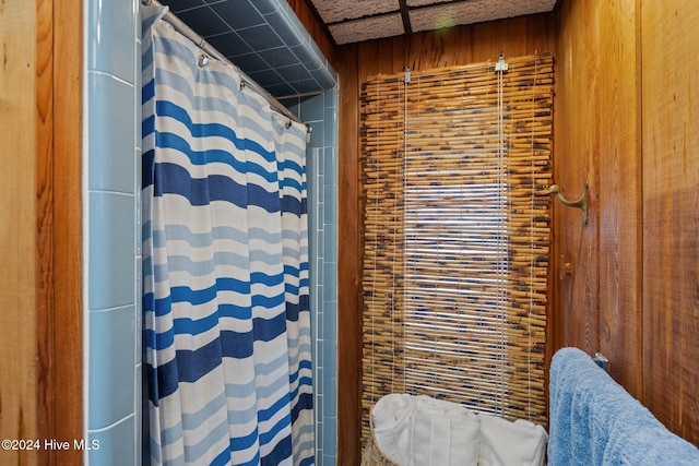 bathroom with wood walls