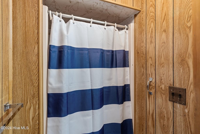 bathroom with wooden walls