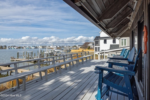 wooden deck featuring a water view and a dock