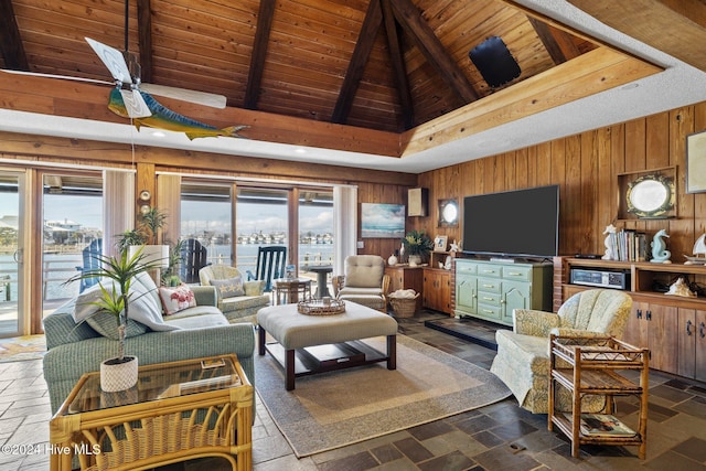 living room featuring beam ceiling, ceiling fan, high vaulted ceiling, wood walls, and wood ceiling