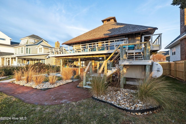 rear view of house with a wooden deck