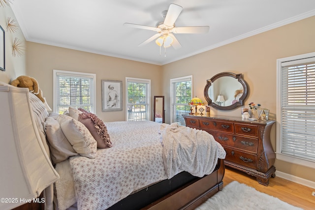 bedroom featuring ceiling fan, crown molding, and light wood-type flooring