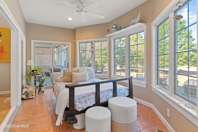 sunroom / solarium featuring ceiling fan and plenty of natural light