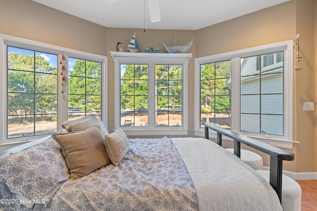 bedroom featuring ceiling fan and multiple windows