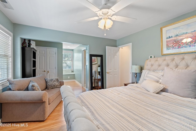 bedroom with ceiling fan and light hardwood / wood-style floors