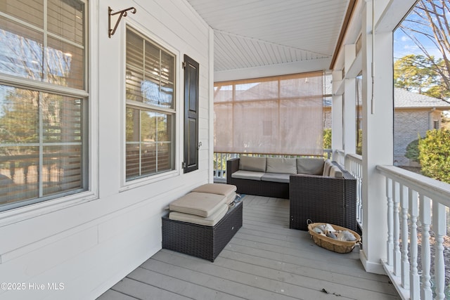 deck with an outdoor living space and a porch