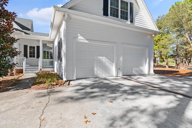 view of property exterior featuring covered porch and a garage