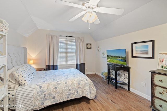 bedroom with light hardwood / wood-style floors, ceiling fan, and lofted ceiling