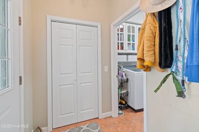 washroom with washer / dryer, light tile patterned floors, and a wealth of natural light