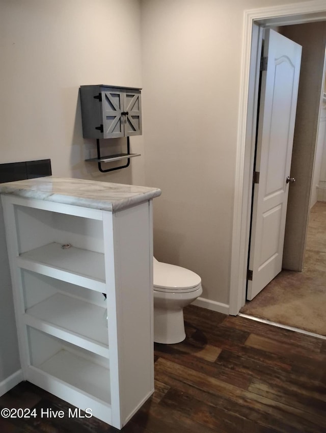 bathroom featuring hardwood / wood-style floors and toilet