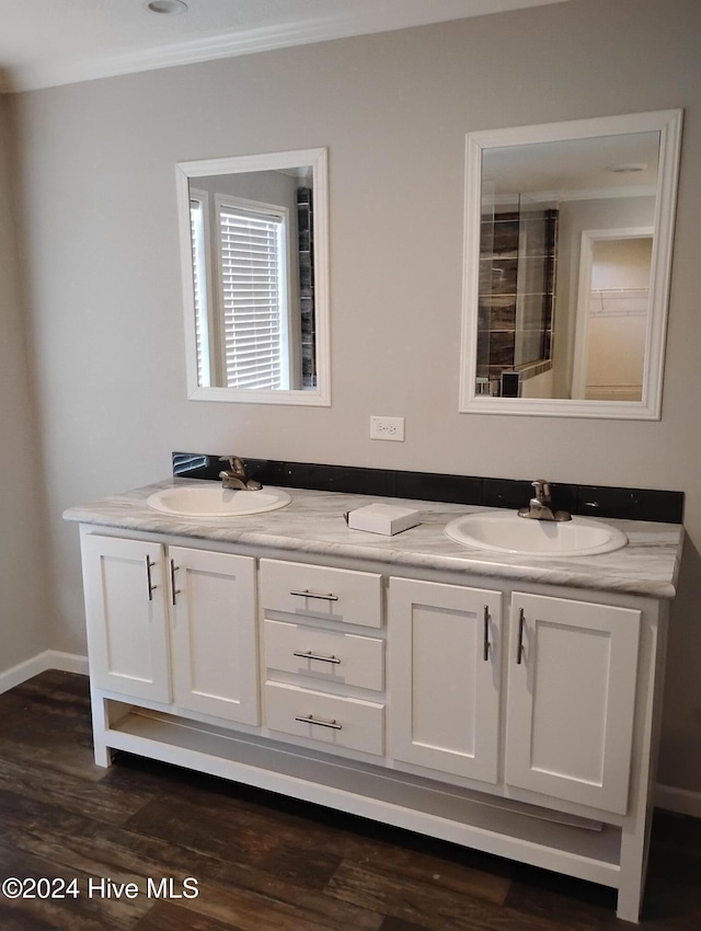 bathroom with crown molding, vanity, and hardwood / wood-style flooring