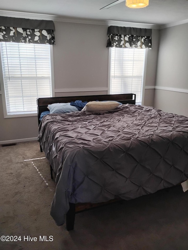 bedroom with carpet flooring, ceiling fan, and ornamental molding