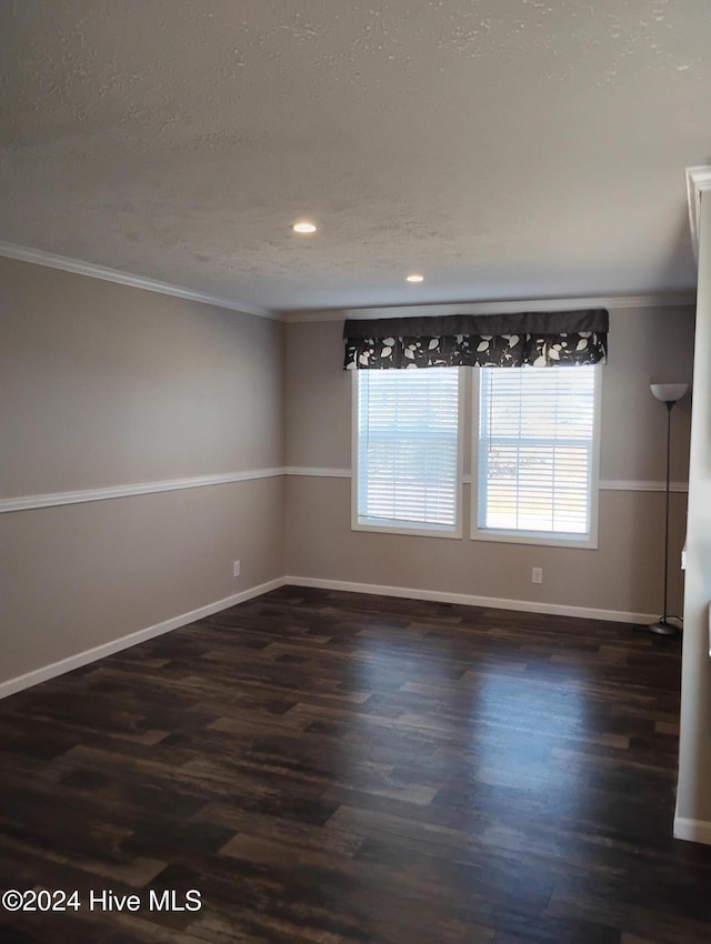 unfurnished room featuring a textured ceiling, dark hardwood / wood-style floors, and ornamental molding