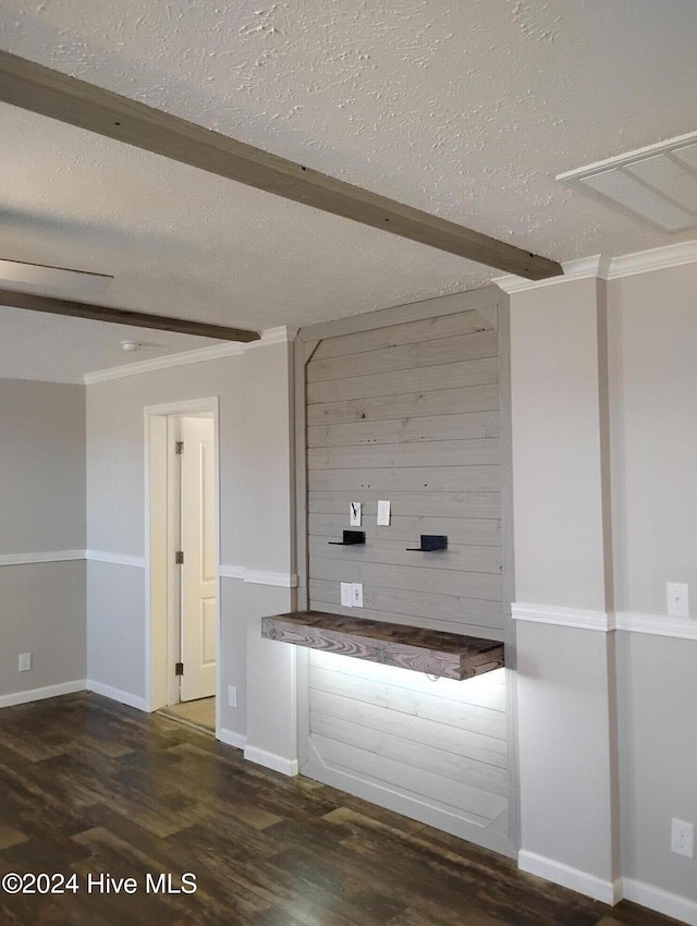 unfurnished living room with beamed ceiling, crown molding, dark hardwood / wood-style flooring, and a textured ceiling