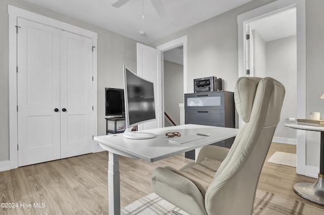 office with ceiling fan and light hardwood / wood-style floors