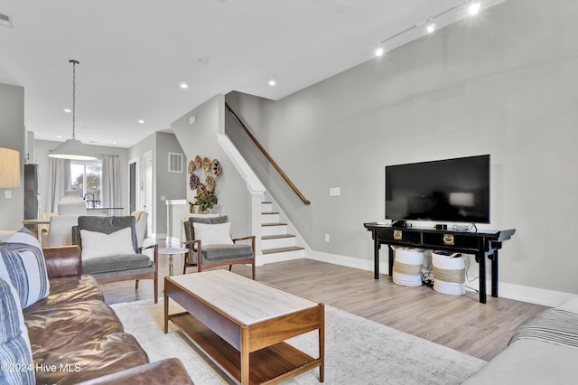 living room featuring light hardwood / wood-style floors and track lighting