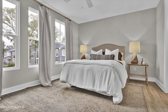 bedroom with ceiling fan and wood-type flooring