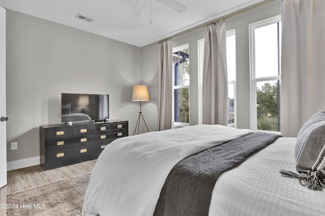 bedroom with hardwood / wood-style flooring and ceiling fan