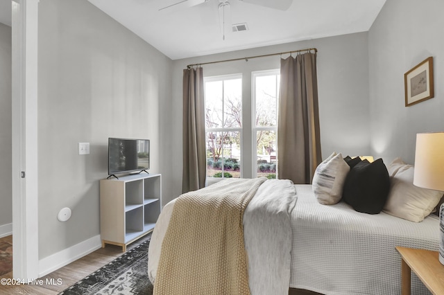 bedroom with hardwood / wood-style flooring and ceiling fan