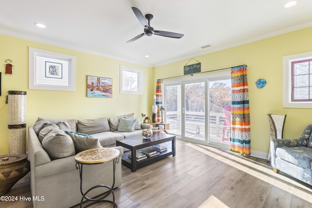 living room with crown molding, ceiling fan, and light hardwood / wood-style floors