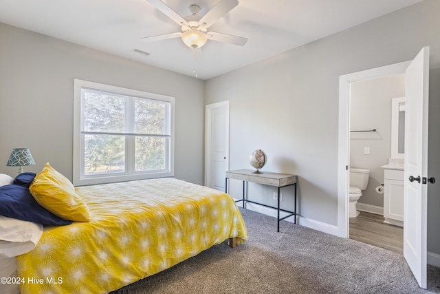 bedroom with carpet flooring, ensuite bathroom, and ceiling fan