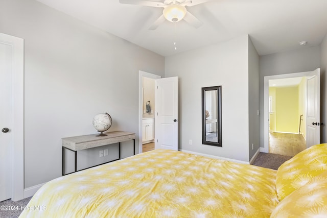 bedroom with ensuite bathroom, light hardwood / wood-style flooring, and ceiling fan