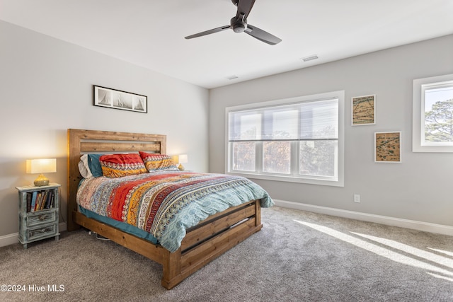 bedroom with carpet flooring, ceiling fan, and multiple windows